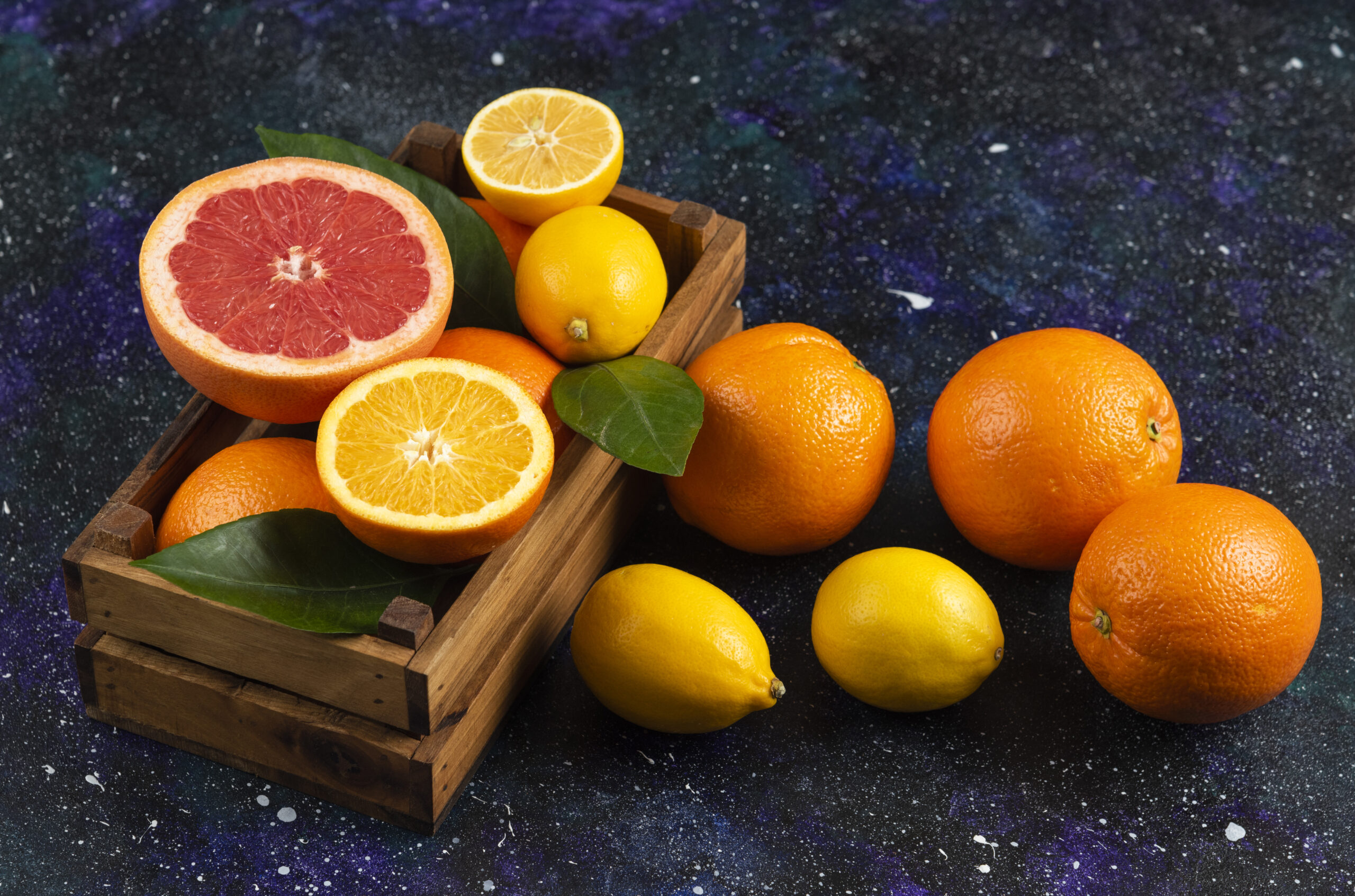 Top view of fresh fruits in wooden basket and ground. High quality photo
